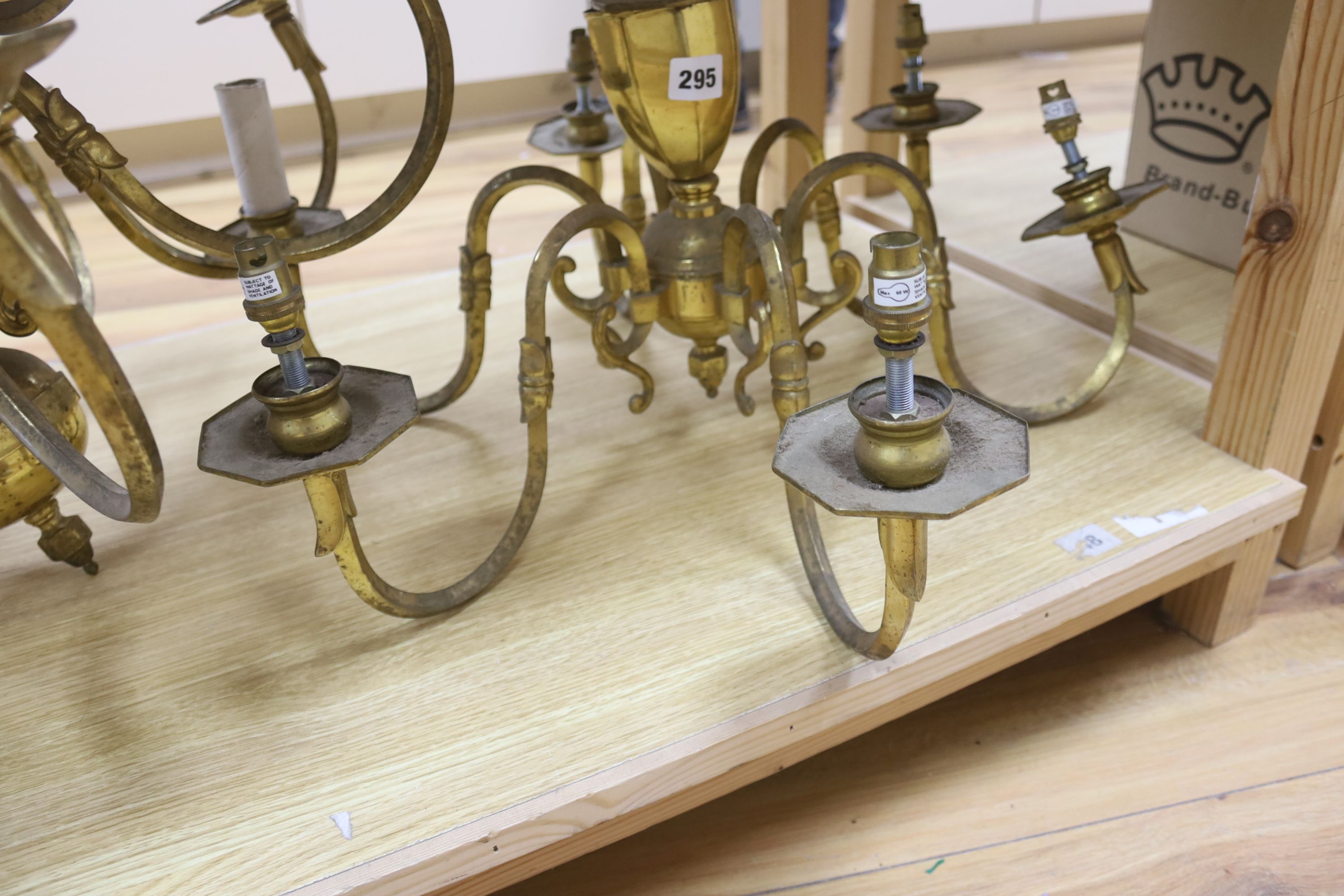 A brass two tier twelve branch electrolier and an associated six branch electrolier